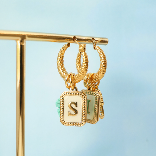 Create a unique collection with stainless steel shell charms with letters