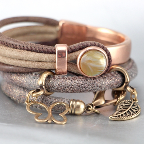 Nice stitched leather with beautiful findings and charms made of Designer Quality metal!