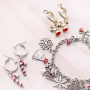 Cheerful Christmas jewellery with gold and silver Christmas charms
