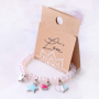 Girly jewellery with cheerful metal charms and soft colours