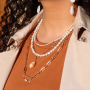 Chain jewellery in combination with freshwater pearls and shell beads
