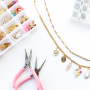 Create a funky charm necklace with metal charms with enamel